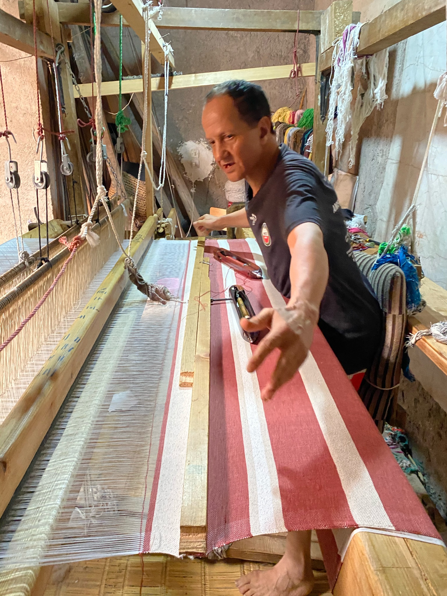 Striped fabric being woven on a traditional loom