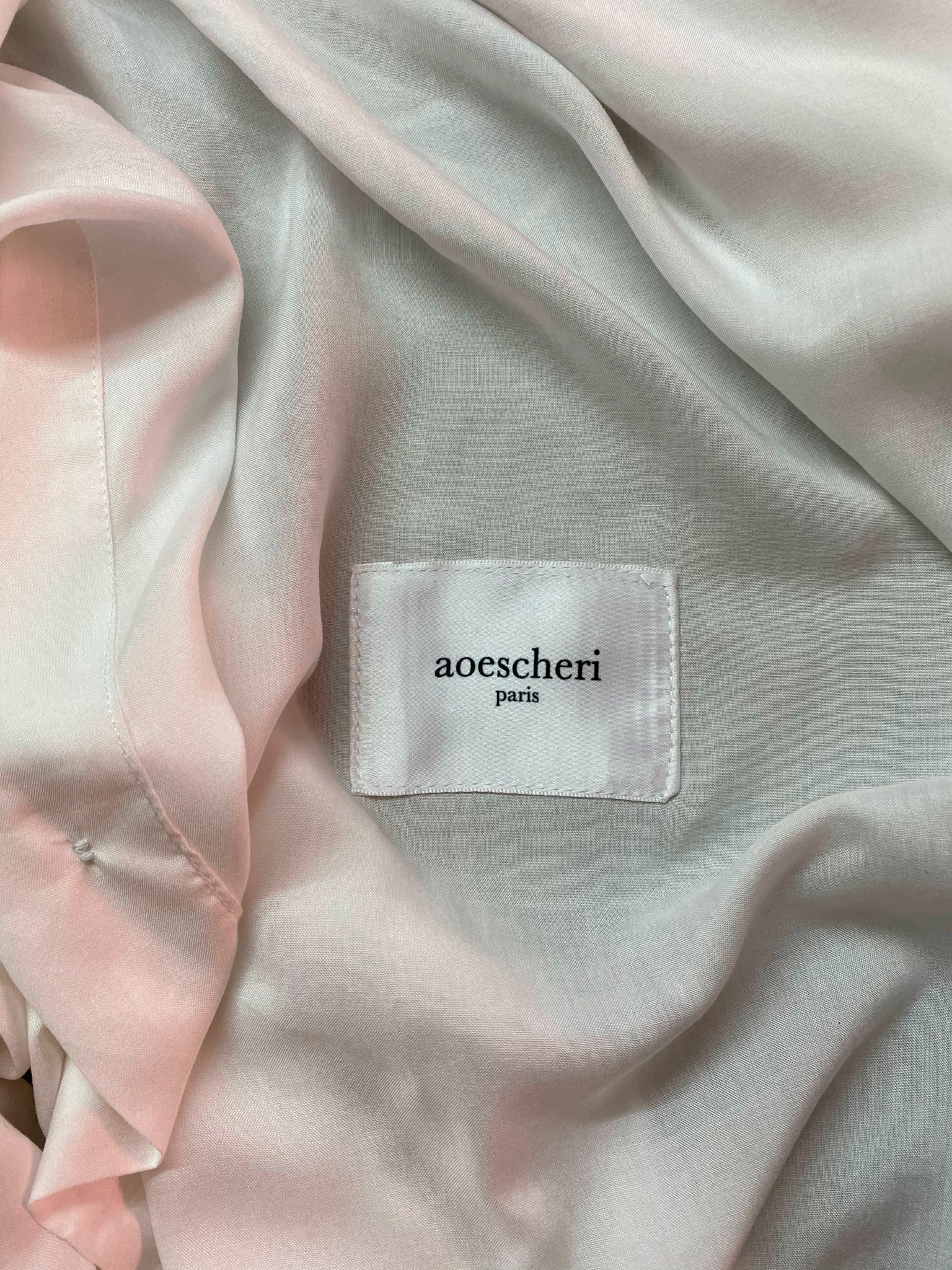 The aoescheri paris label sewn into a garment
