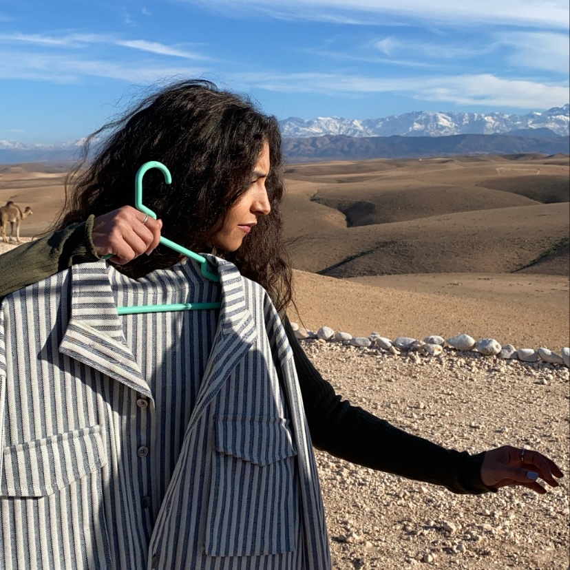 Striped jacket held in the desert wind